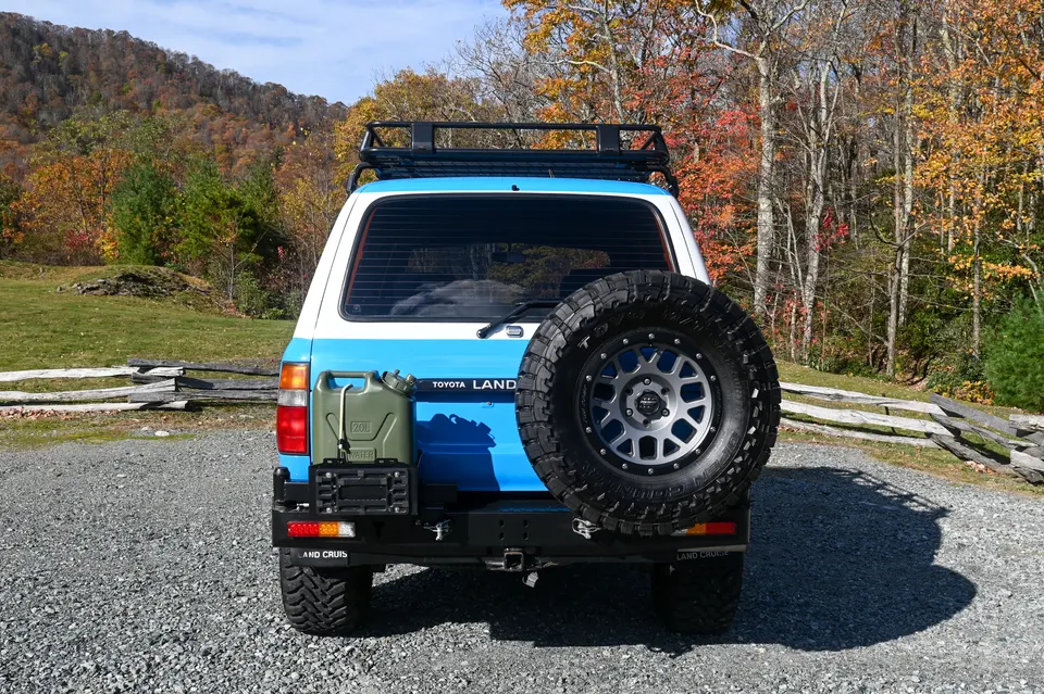 Rear bumper with swing out spare tire carrier