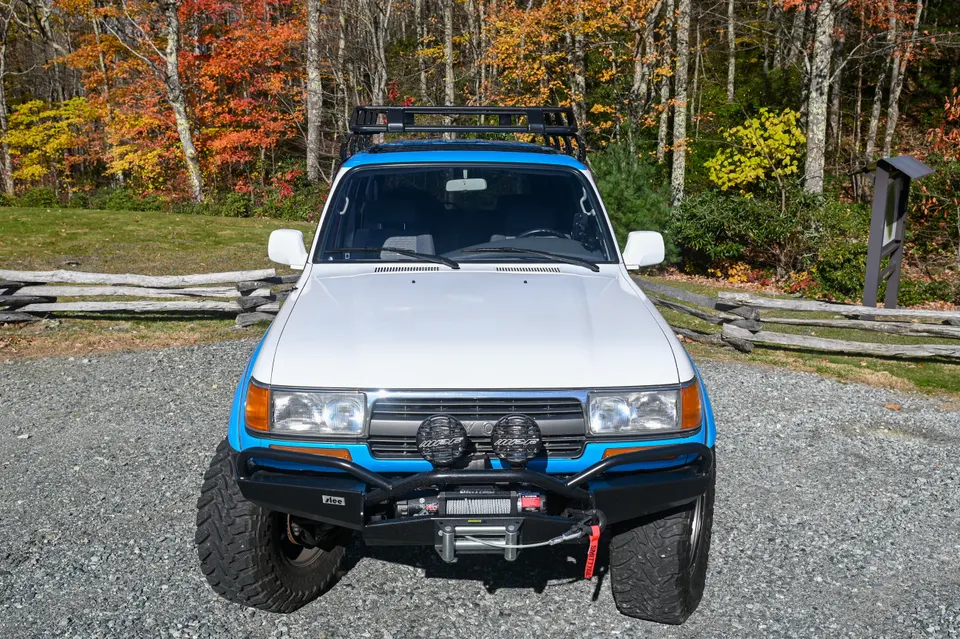 Land Cruiser front three-quarter with mountain backdrop