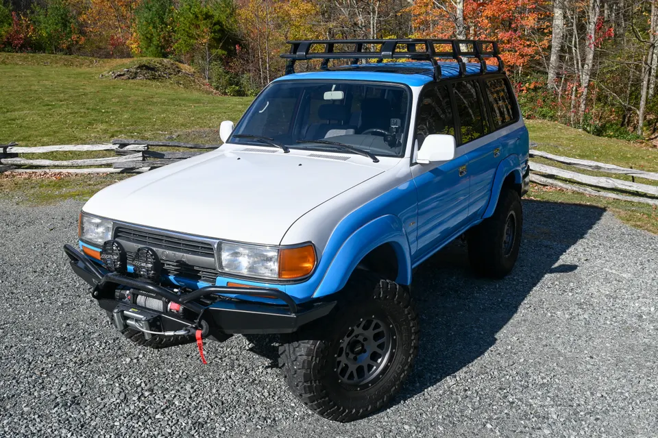 Land Cruiser driver side profile with mountain backdrop