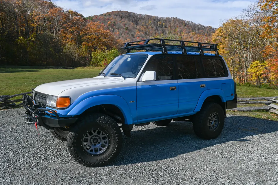 Land Cruiser front three-quarter with autumn trees