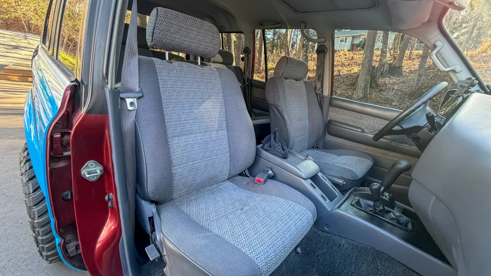 Rear seat area with original red paint visible in the door jamb